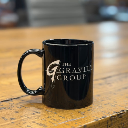 The Gravity Group black ceramic coffee mug – roller coaster engineering company merchandise